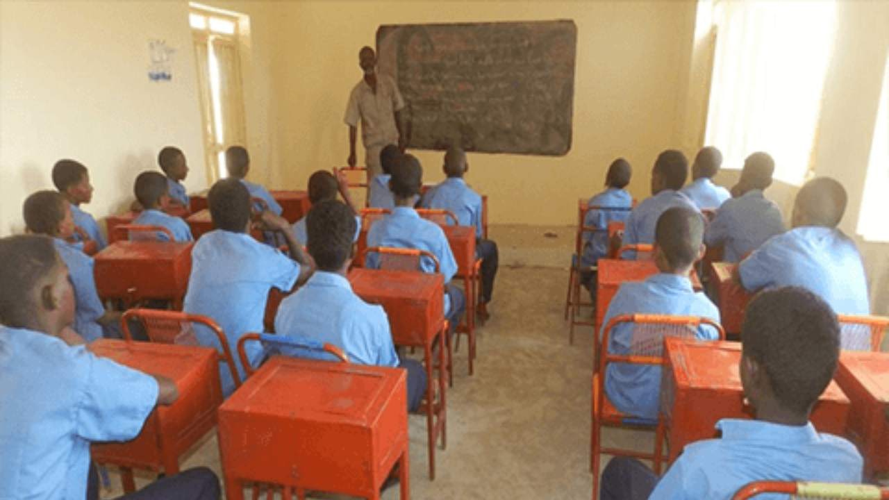 Students learning with a teacher in a classroom